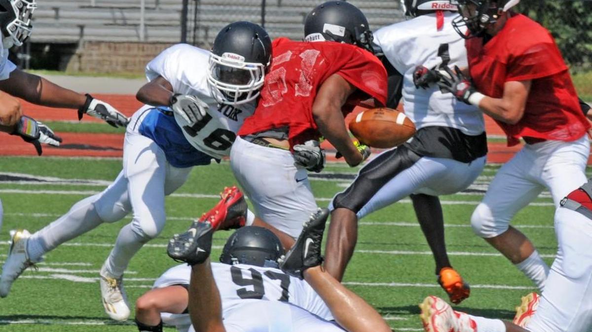 Tajh Reid-Stanley forces a fumble during York’s preseason scrimmage against Hillcrest in early August. The Cougars have depth and experience in the secondary this year.