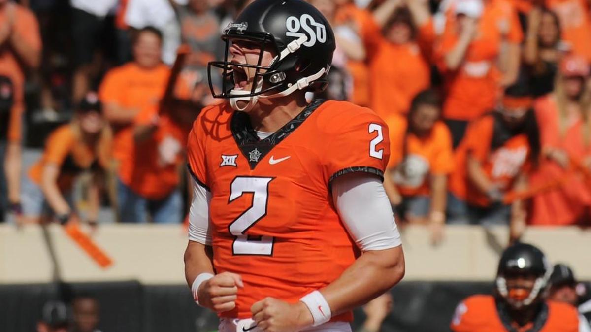Oklahoma State quarterback Mason Rudolph screams after scoring a touchdown in the third quarter of an NCAA college football game against West Virginia in Stillwater, Okla., Saturday, Oct. 29, 2016. Rudolph threw for 273 yards in the Cowboys' 37-20 win.