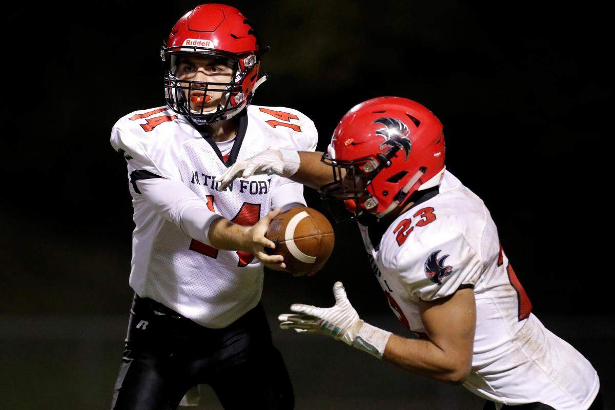 Nation Ford quarterback #14 Gabe Huitt hands off to #23 Nathan Maffey against Indian Land.