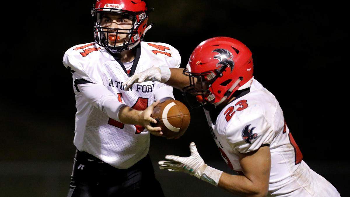 Nation Ford quarterback #14 Gabe Huitt hands off to #23 Nathan Maffey against Indian Land.