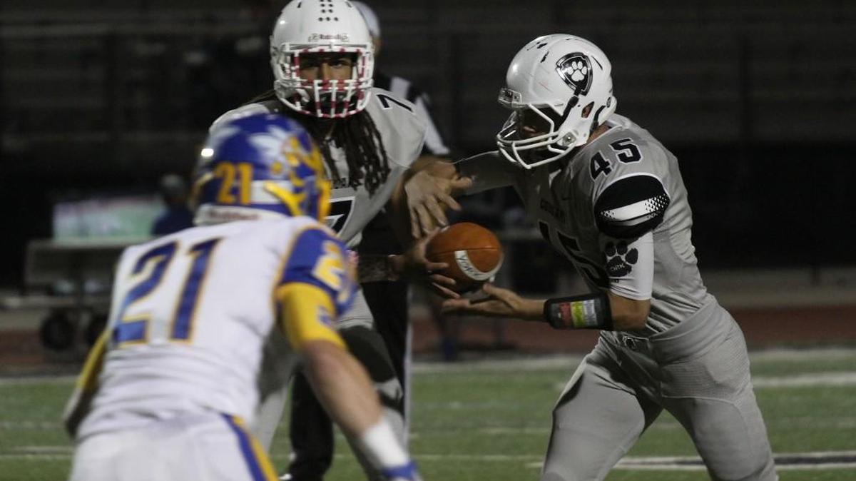 York quarterback Wally Wilmore hands off to Brandon Garvin.