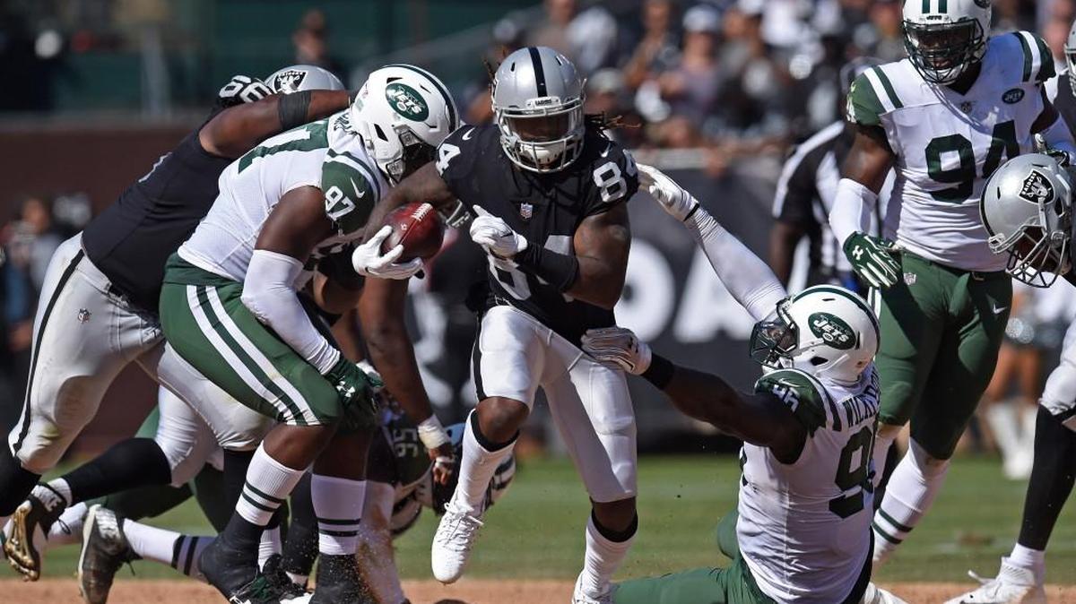 Oakland Raiders' Cordarrelle Patterson (84) breaks a tackle and runs for a touchdown against the New York Jets in the third quarter on Sunday, Sept. 17, 2017 at the Oakland Coliseum in Oakland, Calif. The Oakland Raiders defeated the New York Jets 45-20.