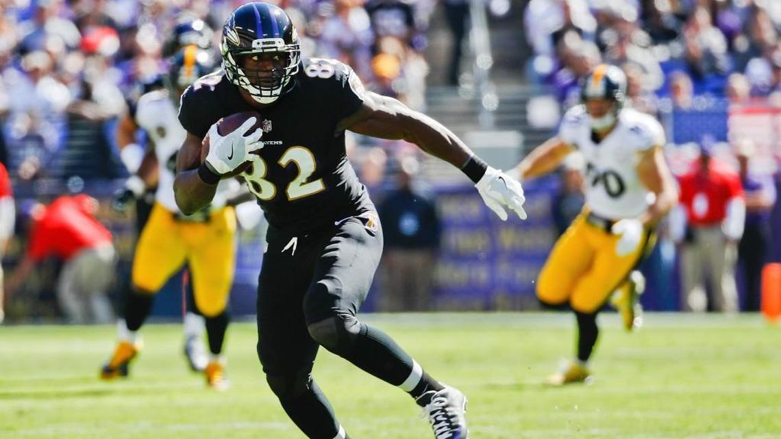 This Oct. 1, 2017 photo shows Baltimore Ravens tight end Benjamin Watson (82) carrying the ball during the first half of an NFL football game against the Pittsburgh Steelers in Baltimore. Watson, along with J.J. Watt and Greg Olsen, was a finalist for the NFL’s Walter Payton Man of the Year award in 2018.
