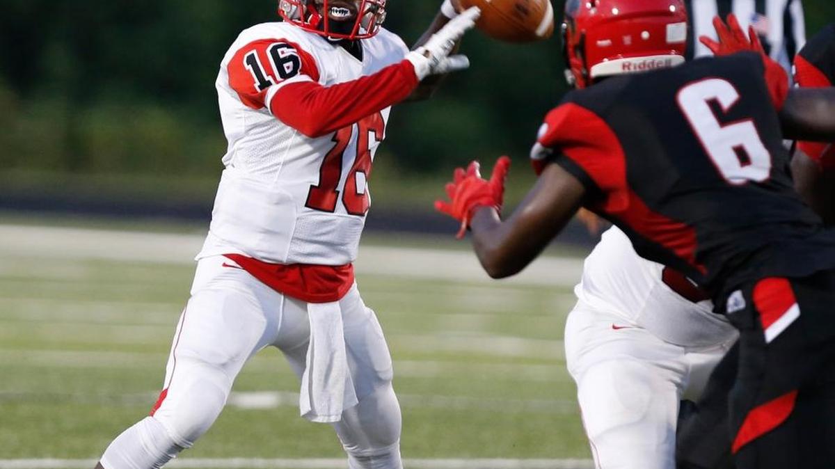 
FILE. South Pointe quarterback Greg Ruff (16) is pressured by Nation Ford's Tay Sauls (6).
