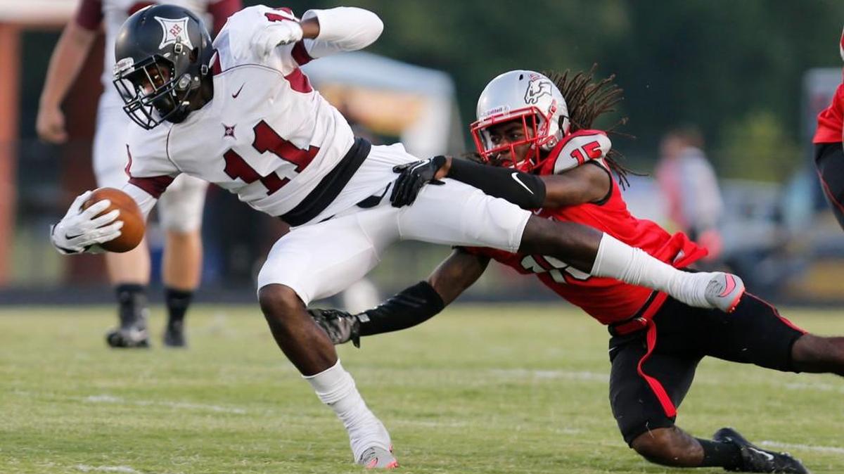 South Pointe hosts Rock Hill August 28, 2015. Rock Hill's Thiland Adams (11) is taken down by South Pointe's Chris Smith (15).