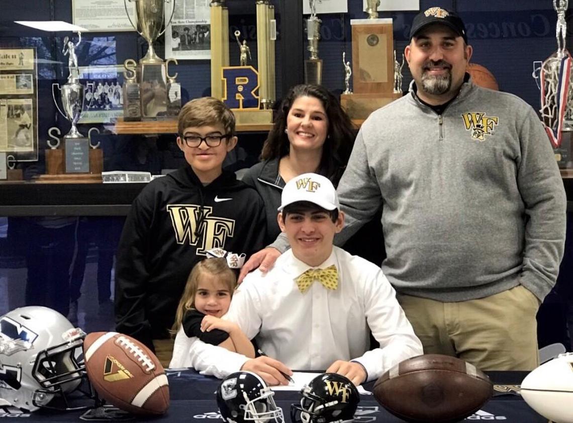 Nick Sciba (center) signed with Wake Forest University, while surrounded by his family (clockwise from back left) Braden, Nikki, Brian and Emery.