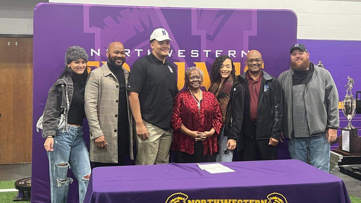 Knox (third from left, white hat) poses for pictures with his family at his early signing day.
