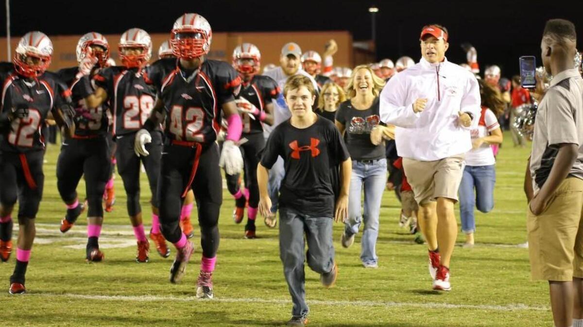 Dalton Herron can handle the loud and bright environment of Friday night football, a relief to his dad, South Pointe football coach Strait Herron. He knows he’ll never be able to coach his son, but having him at the games is just as good.