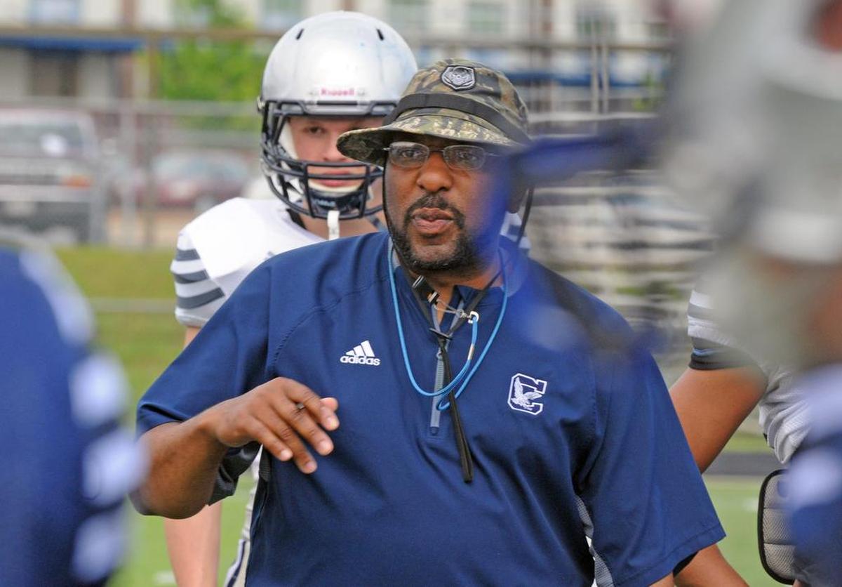Clover football head coach Brian Lane speaks to his players in a 2017 preseason game.