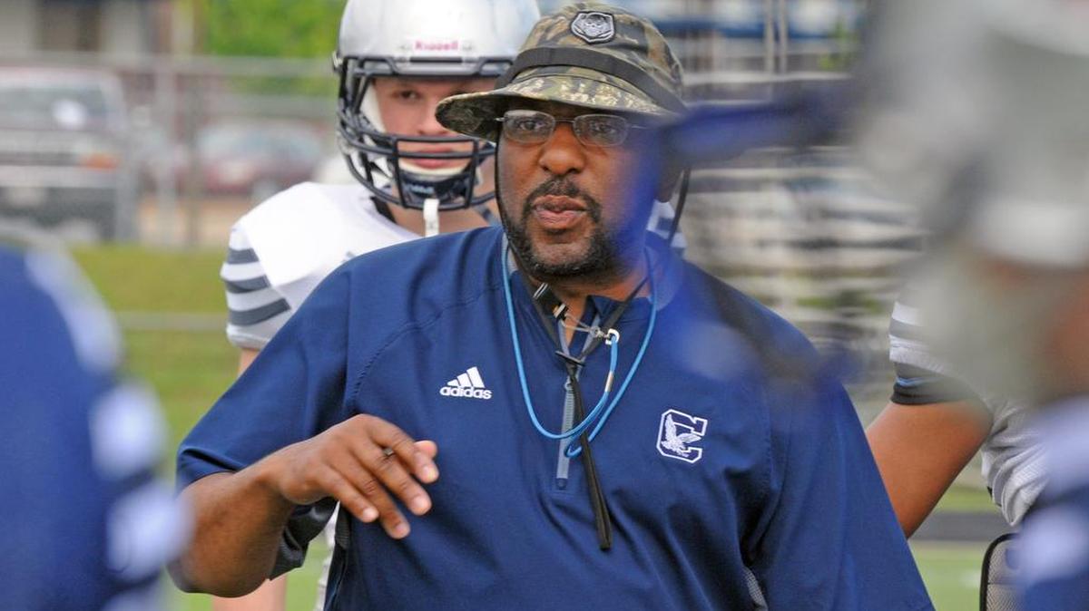 Clover football head coach Brian Lane speaks to his players in a 2017 preseason game.