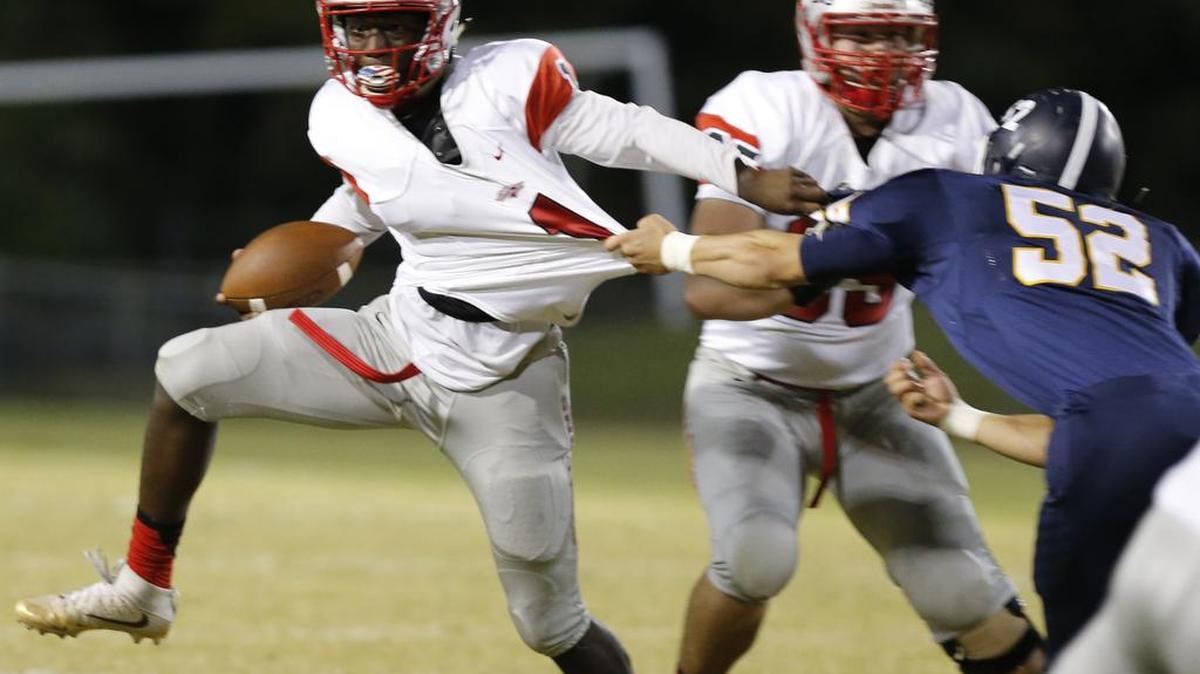 South Pointe quarterback Derion Kendrick is taken down by Lancaster's Alex Steele in the first quarter Friday at Lancaster.