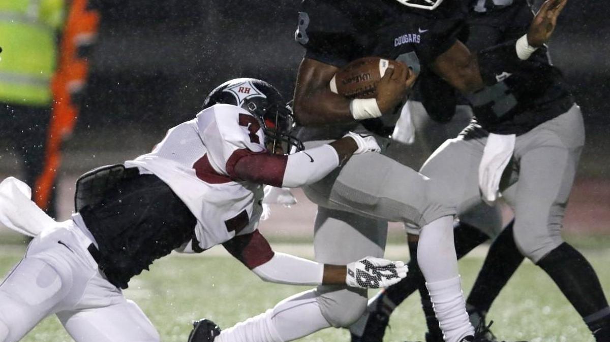 
Rock Hill defender Kentrell McCrorey (7) takes down York running back Paul Moore (8) in York on Friday. 
