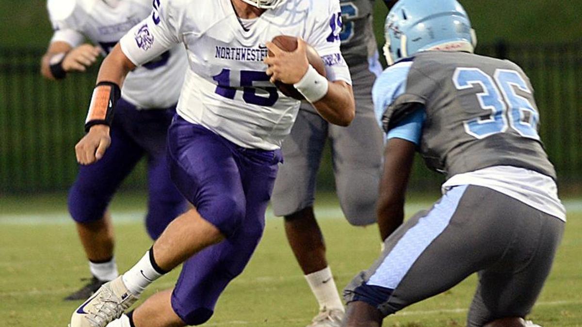Dorman played Northwestern in high school football at Dorman High School on Aug. 26, 2016. Trojans quarterback Gage Moloney with the ball.