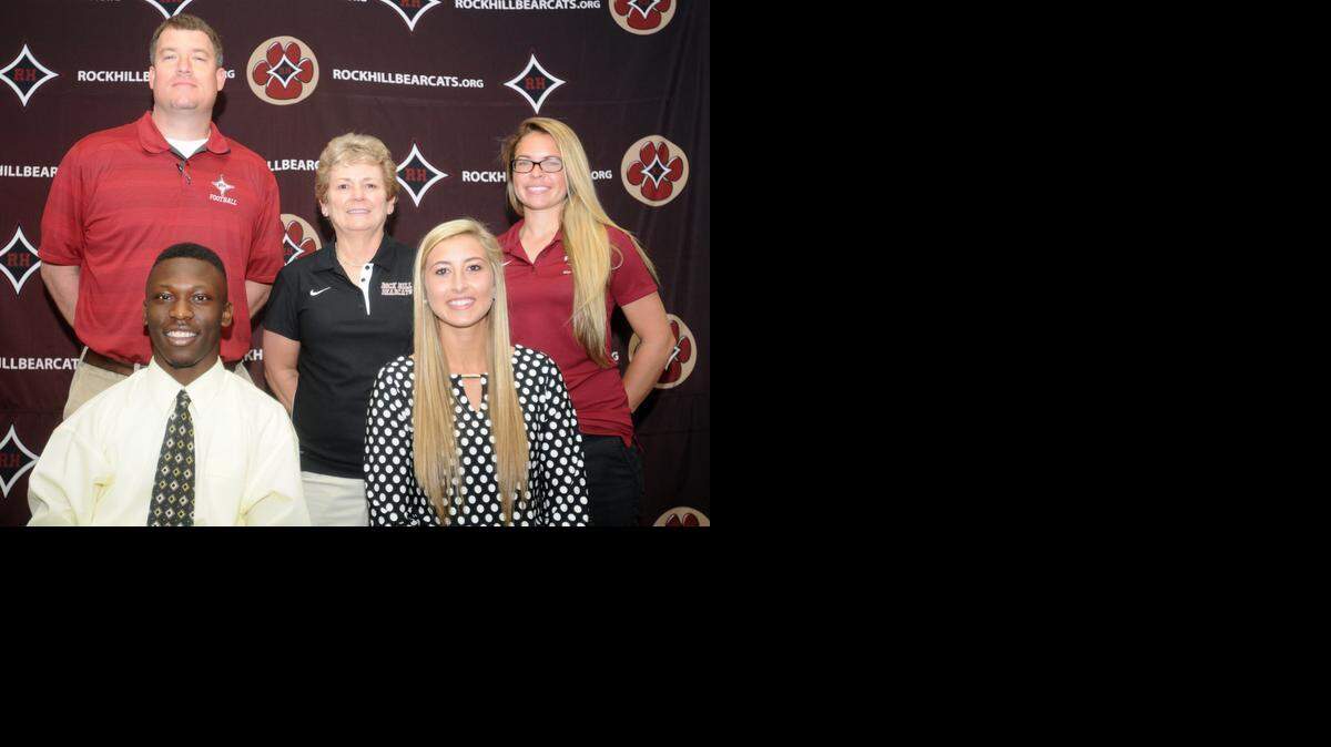 
Rock Hill's Deshaun McFadden (left) and Bayley Hinson were joined by their coaches Thursday morning as they signed to play college sports. McFadden will play football at N.C. A&T and Hinson will play volleyball at first-year program USC Lancaster. Rock Hill football coach Bubba Pittman, volleyball coach Cindy Elder and softball coach Alisha Waldrop are in the back row.
