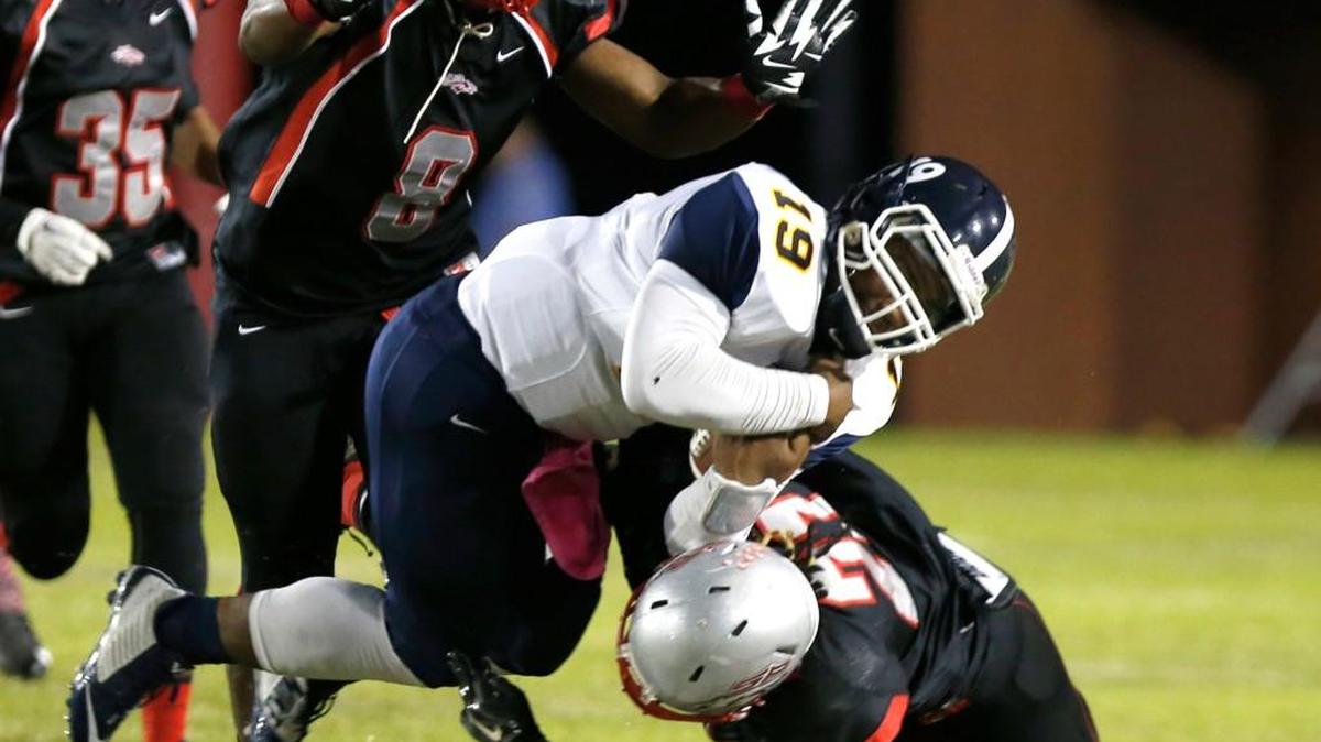
Lancaster's quarterback Darius Robinson is taken down by South Pointe's Marquarius Brice, right, and Shavares Crockett in Friday night’s game.
