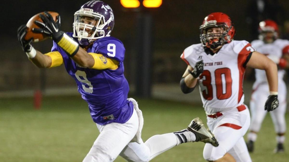 Northwestern’s Jordan Starks (9) hauls in a pass ahead of Nation Ford defender Vinnie Caton (30) in the first quarter Friday at District Three Stadium in Rock Hill.