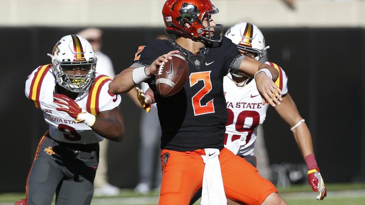 Oklahoma State quarterback Mason Rudolph (2) throws under pressure from Iowa State defenders Reggan Northrup (9) and Kane Seeley (29) in the third quarter of an NCAA college football game in Stillwater, Okla., Saturday, Oct. 8, 2016.