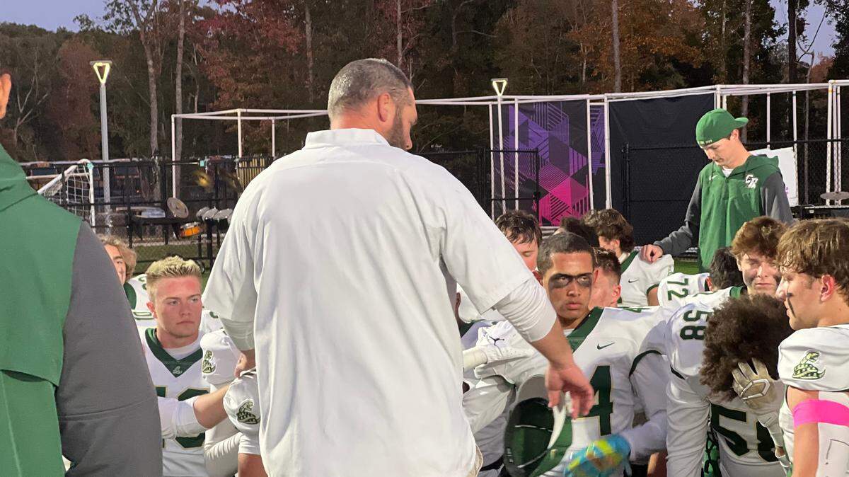 Catawba Ridge head coach Zac Lendyak (white shirt, middle) talks to his team ahead of the Copperheads 36-21 victory over Indian Land. Lendyak said that the team pushed through a lot of adversity in order to get the victory.