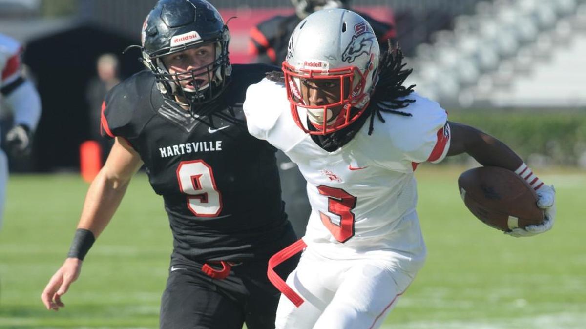 South Pointe's Steven Gilmore Jr. carries the ball as Hartsville's Logan Carpenter follows during the Stallions’ 4A state championship win Saturday in Columbia.