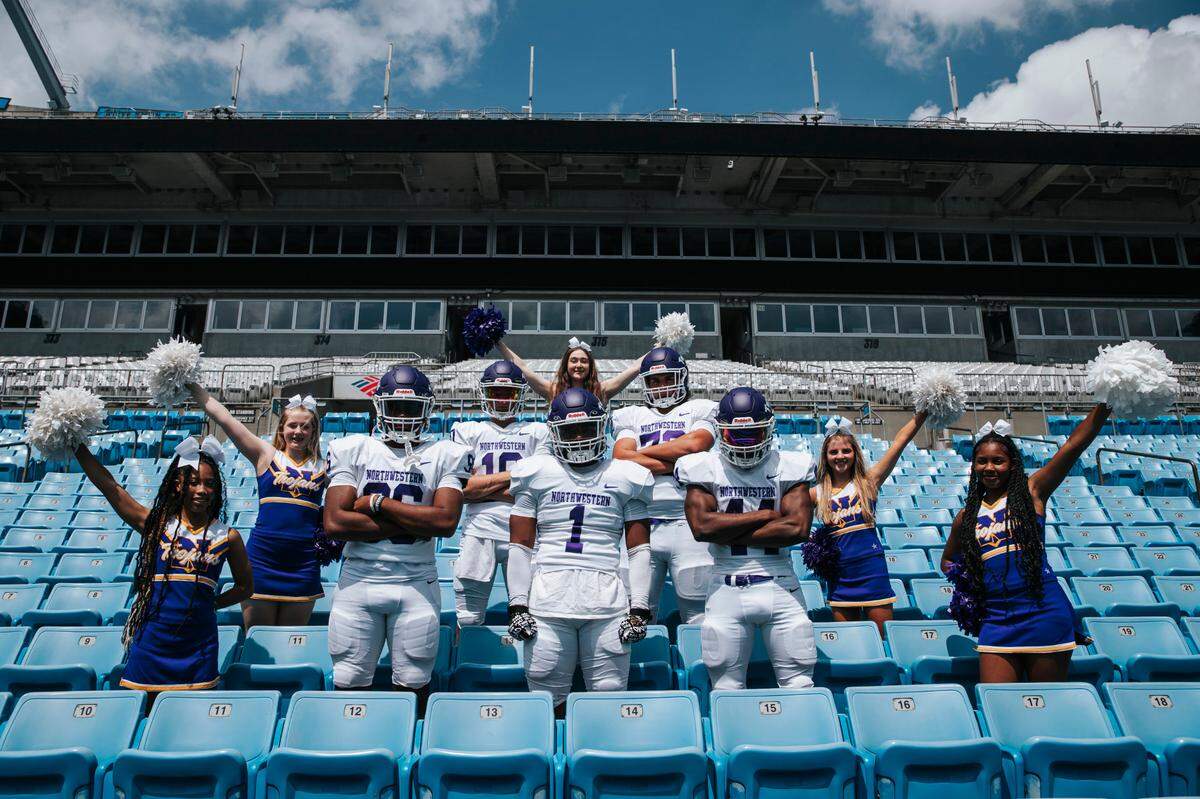 Trojans football players and cheerleaders pose during their media day session held at Bank of America Stadium earlier this year.