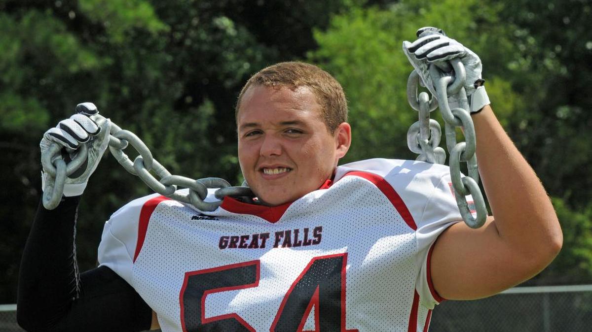 Jamie Craig adjusts a prop during team pictures at Great Falls in early August. The Red Devils return all five offensive line starters, including Craig.