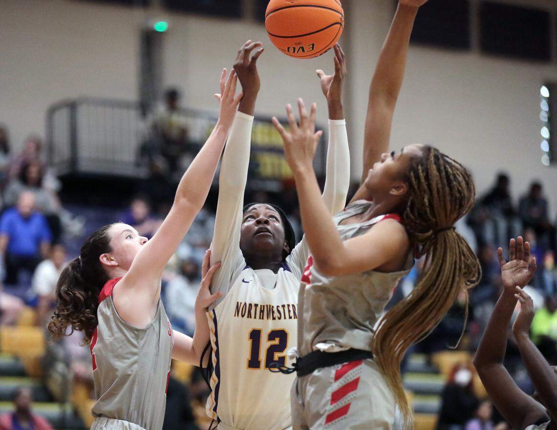 Northwestern’s Dekayla Starr (12), South Pointe’s Taylor Stehmeier, left, and Victoria Starr Morris reach for the ball.