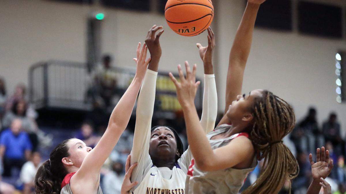 Northwestern’s Dekayla Starr (12), South Pointe’s Taylor Stehmeier, left, and Victoria Starr Morris, right, reach for the ball.