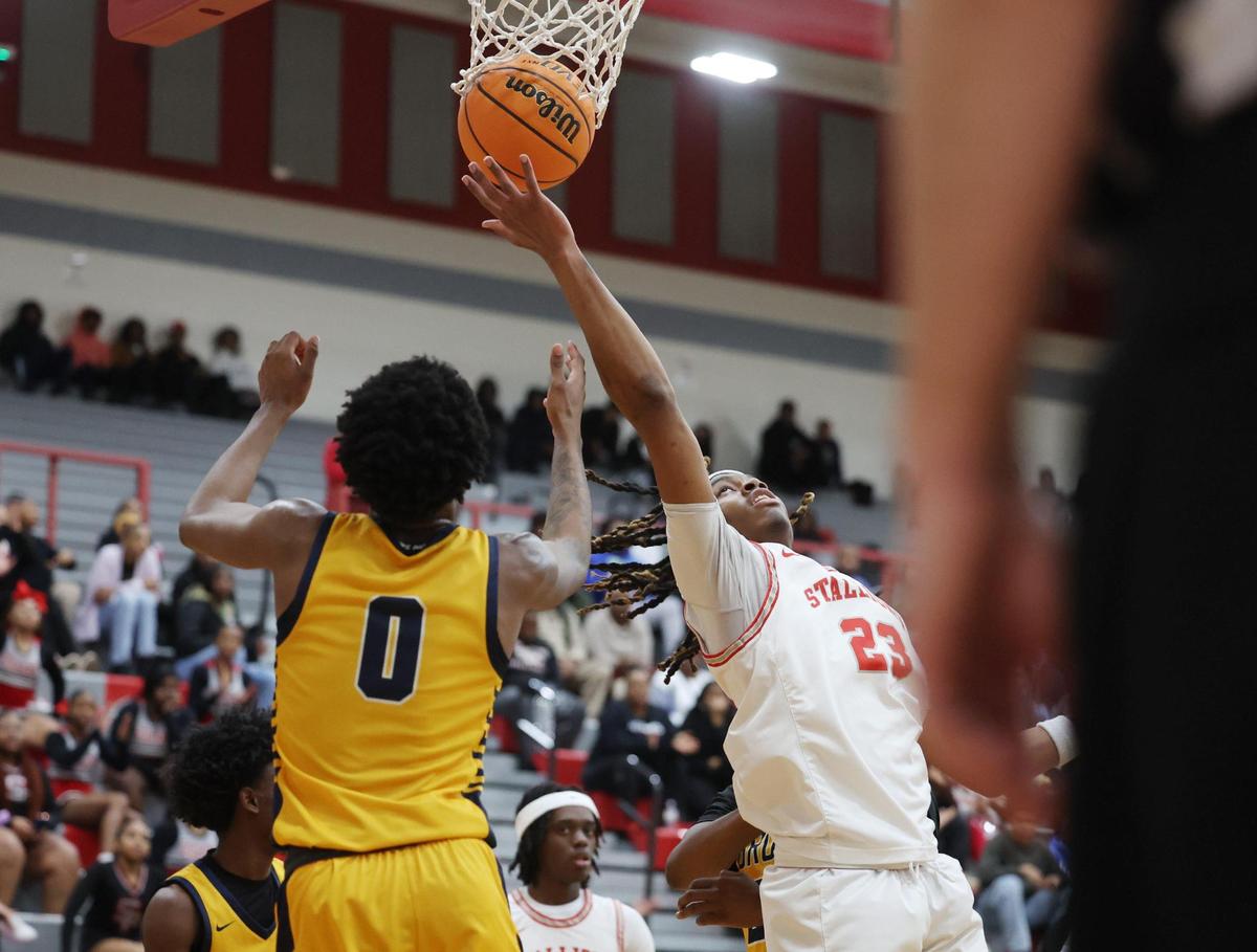 South Pointe High School’s R.J. Hill puts up the shot against Lancaster’s Jordan Watford Tuesday in Rock Hill, S.C.