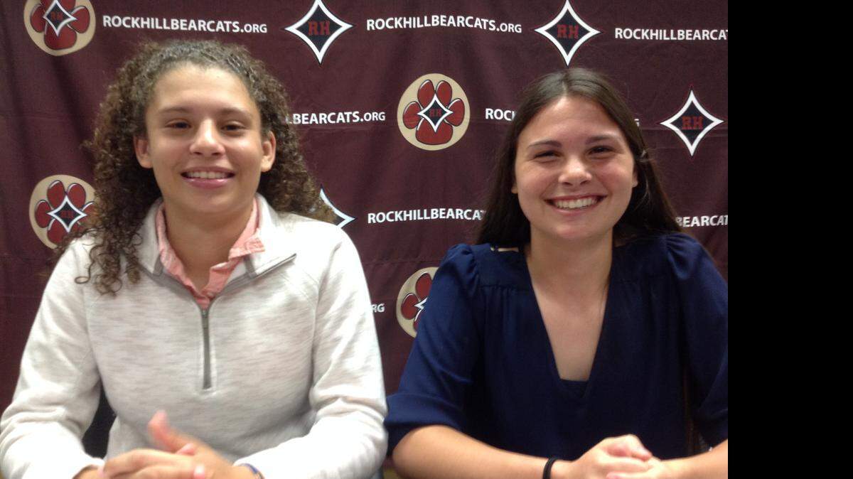
Rock Hill’s Anita Jones (left) and Rebekah Addison put pen to paper on Wednesday, continuing their academic and athletic careers in college.
