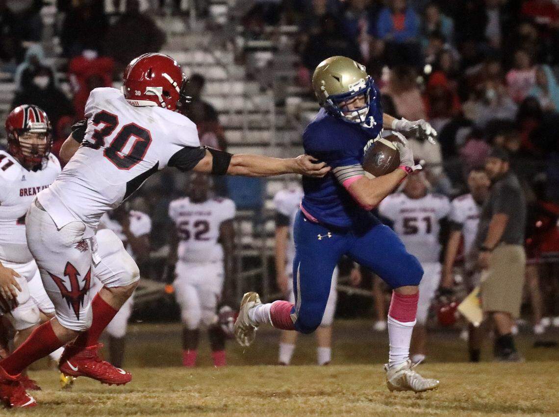 Lewisville’s Jayden Barnes carries the ball against Great Falls’ Scott Blackmon (30) Friday in Richburg.