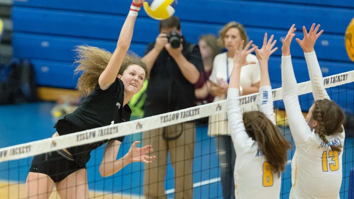 Nation Ford's Sophie Fischer (12) spikes the ball over the net against Fort Mill when the teams played on Oct. 12.