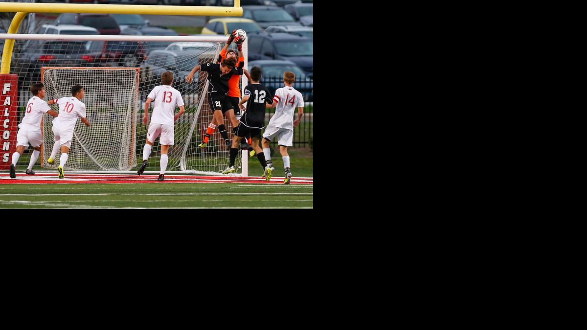 
Nation Ford's goalkeeper Cooper Morris gets up over Rock Hill's No. 21 Jack Westover for the save as Nation Ford hosts Rock Hill in boys varsity soccer, 4-7-2015.
