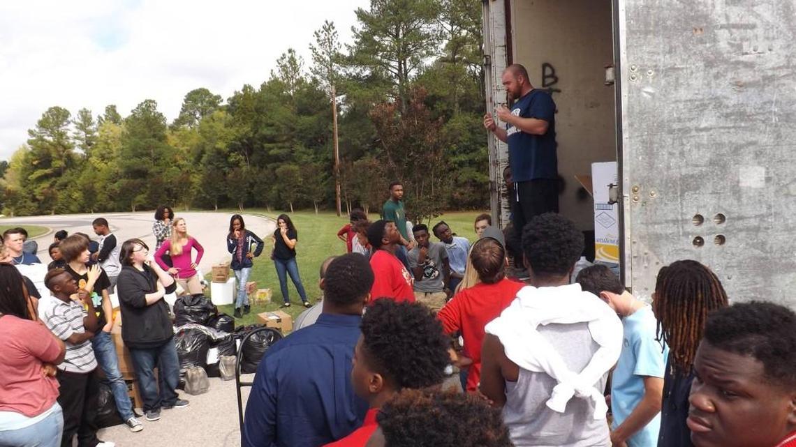 
Chester baseball coach Chris Powell organizes students before beginning to fill a 53-foot tractor trailer with supplies for victims of the South Carolina flooding.
