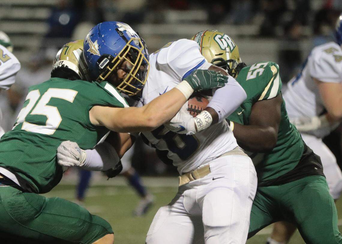 Indian Land’s Dumkele Idehen is brought down by Catawba Ridge’s Forrest Rozelle (35) and Asa Johnson (55) as the Warriors compete with the Copperheads in Fort Mill in the 2021 high school football season.