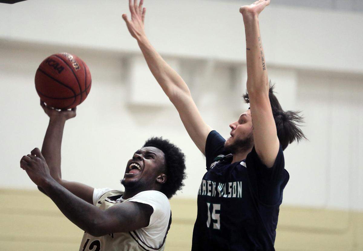 Clinton’s Cameron Shannon shoots against Warren Wilson’s Jerry Daye.