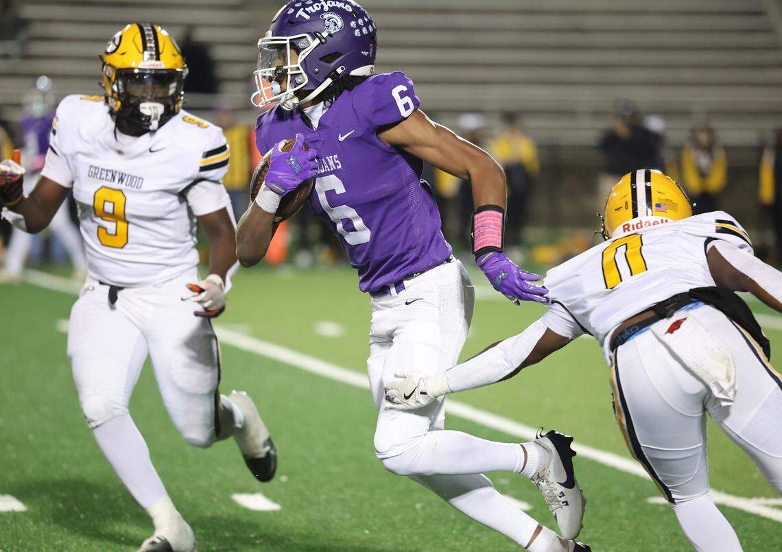Northwestern’s Daniel Caldwell carries the ball against Greenwood’s Khamari Griffin (0) and Damarion Roman (9)