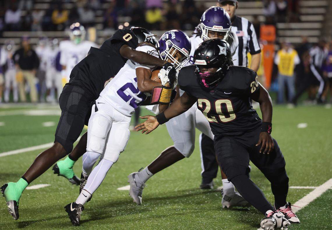 Northwestern's Daylen Shankle is brought down by Rock Hill's Kimari Barber (0) and Kaleb Wright (20) Friday, Oct. 17, 2025 in Rock Hill, S.C.