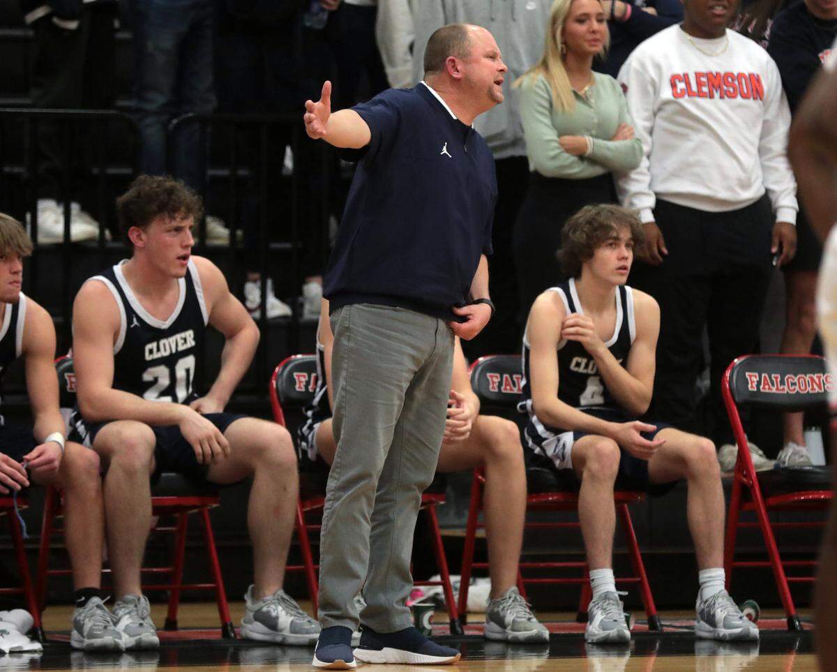 Clover boys basketball coach Bailey Jackson talks to a player Friday as the Falcons and Blue Eagles compete in Fort Mill.