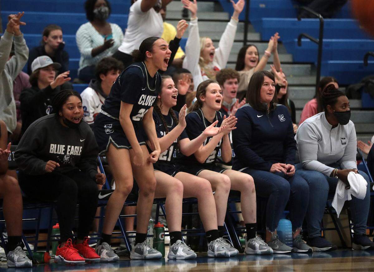 The Clover High School varsity girls basketball team cheer as they take on the Fort Mill Yellow Jackets in a 2021-22 regular season game.