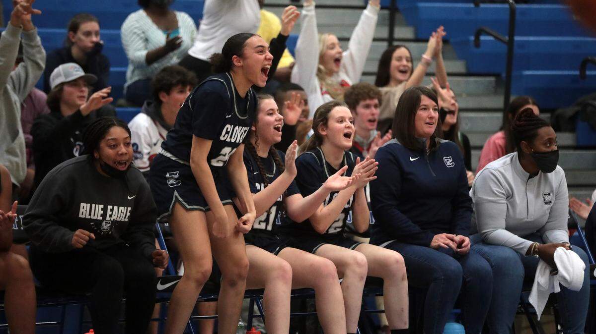 The Clover High School varsity girls basketball team cheer Wednesday as they take on the Fort Mill Yellow Jackets.