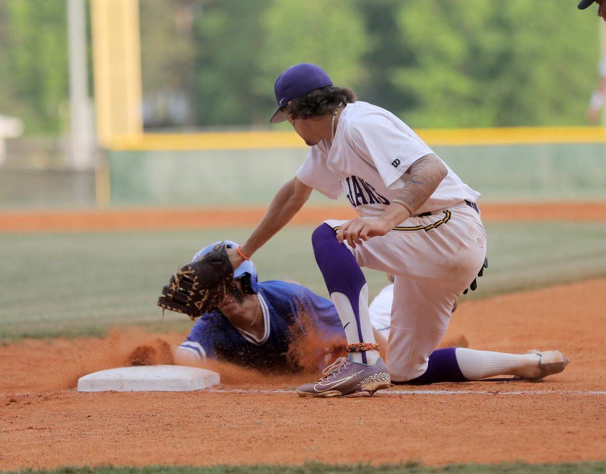 Northwestern’s Ethan Darden tries to tag a Byrnes baserunner at first base Thursday in Rock Hill.