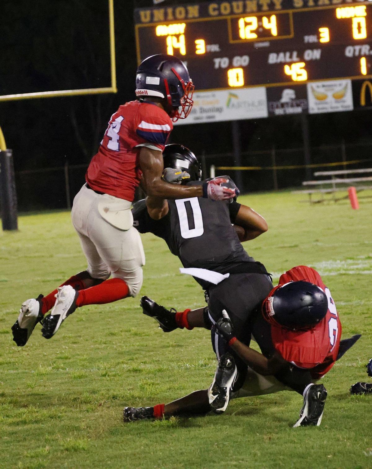 Chester’s Zy Whitlock, right tackles York’s Johnathan Tobias (0) as Chester’s Jordan Chisholm tries to assist Whitlock Friday at a scrimmage in Union.