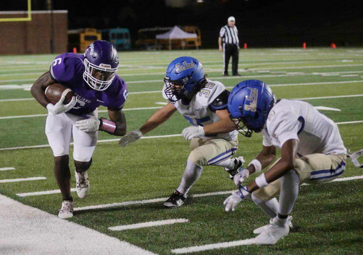Northwestern’s Zilon Arnold (6) is driven into the sideline by Indian Land’s Mikey Johnson (35) and Keyon Kiles.