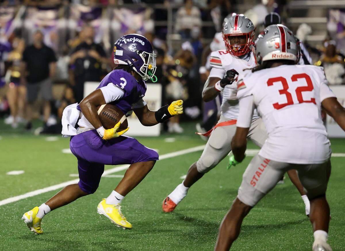 Northwestern’s Kameron Vance carries the ball as the Trojans compete againts the South Pointe Stallions in a mid-September game.