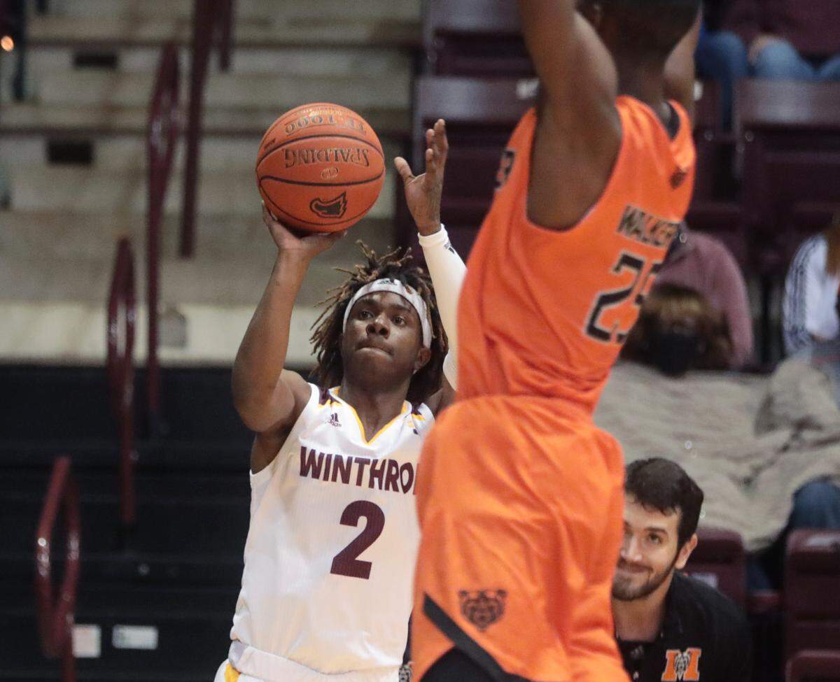 Winthrop’s Sin’cere McMahon takes the shot as Mercer’s Shawn Walker Jr. tries to block him in the Eagles’ home game Saturday, Nov. 13, 2021.