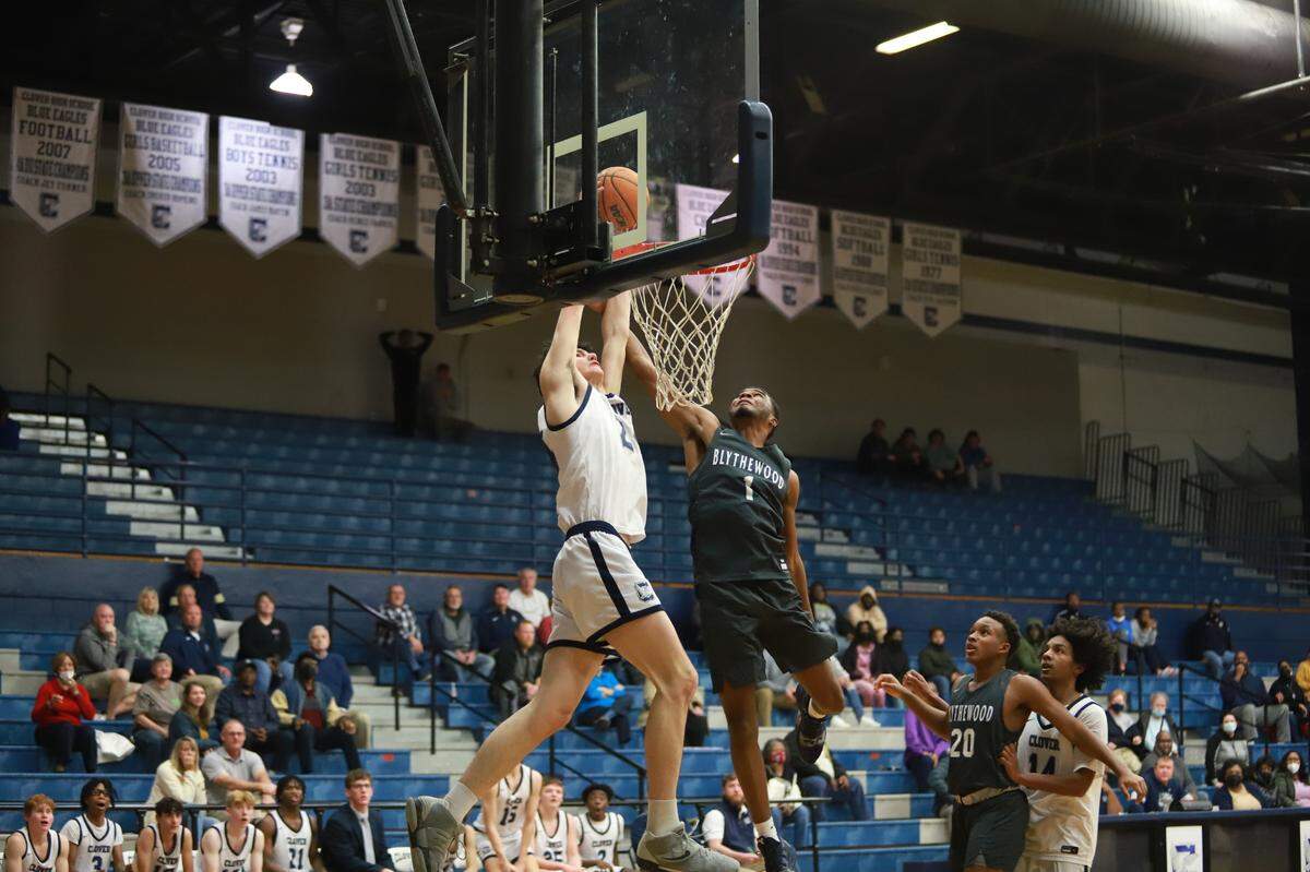 Clover’s Lawrence Bartee dunks over a defender in his team’s win over Blythewood in the 2022 state playoffs.
