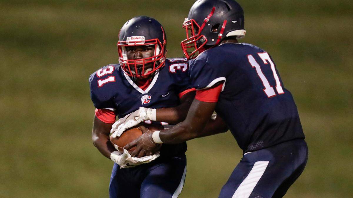 Chester quarterback (17) Zan Dunham hands off to Chester’s (31) Shydem McCullough in first half play as Chester hosts Northwestern in Friday night football 9-10-2021. McCullough was voted as a Week 6 Player of the Week by the Tri-County Coaches Association and Player of the Week on The Herald’s fan poll.