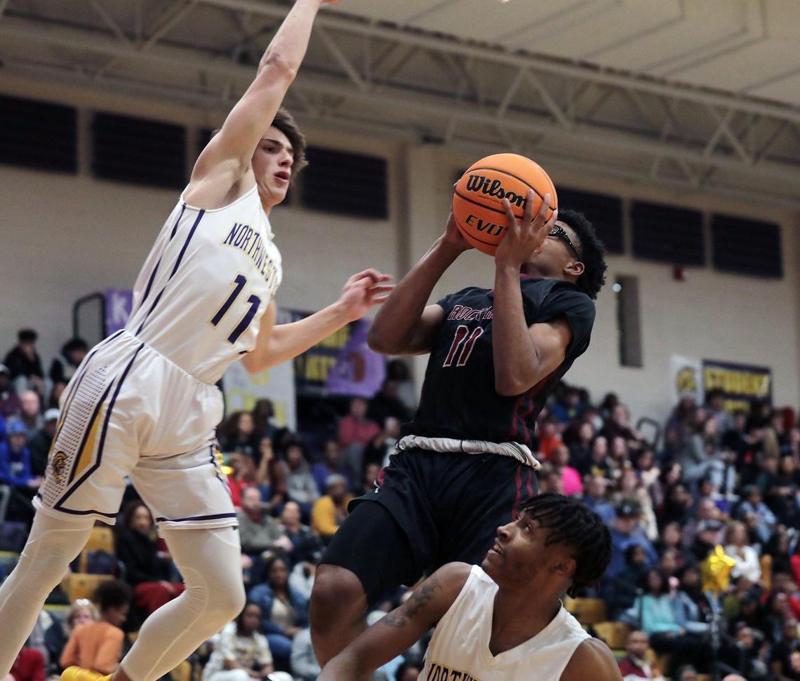 Rock Hill’s Josh Stradford tries to put up the shot as Northwestern’s Mason Grigg blocks it Friday at Northwestern High School.