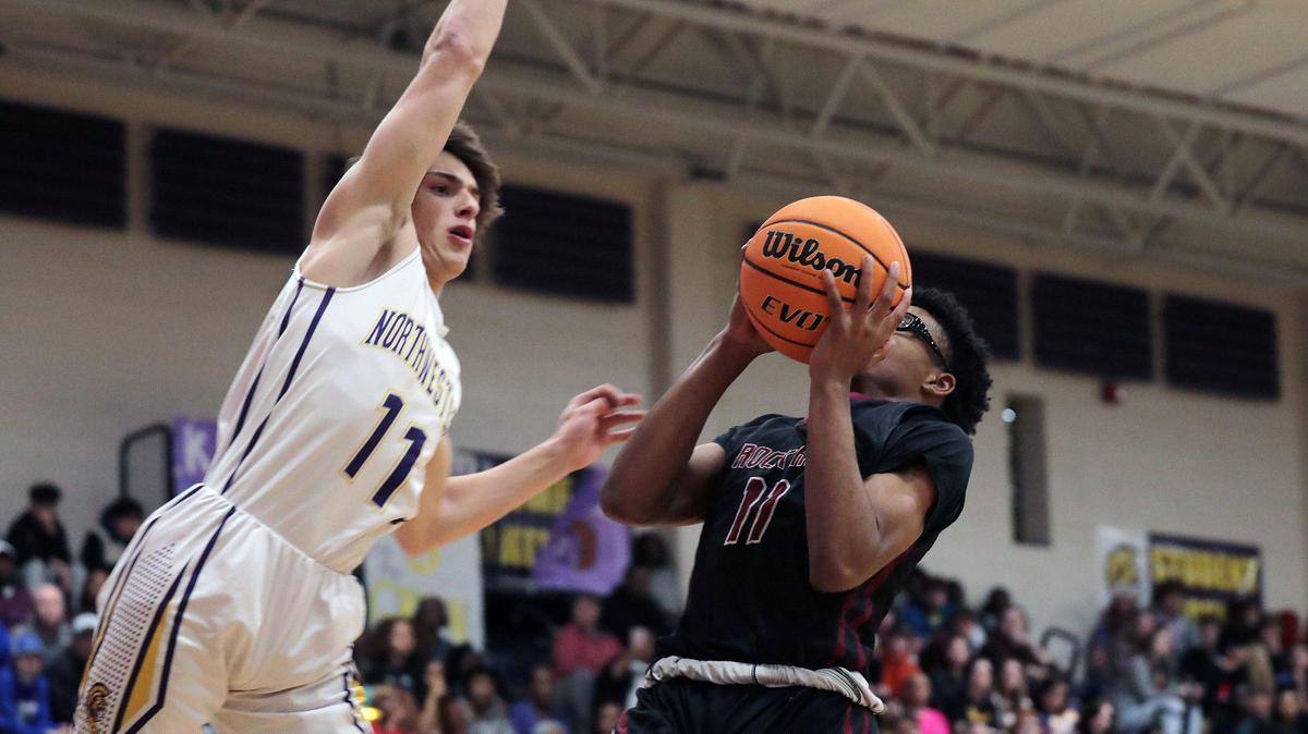 Rock Hill’s Josh Stradford tries to put up the shot as Northwestern’s Mason Grigg blocks it Friday at Northwestern High School.