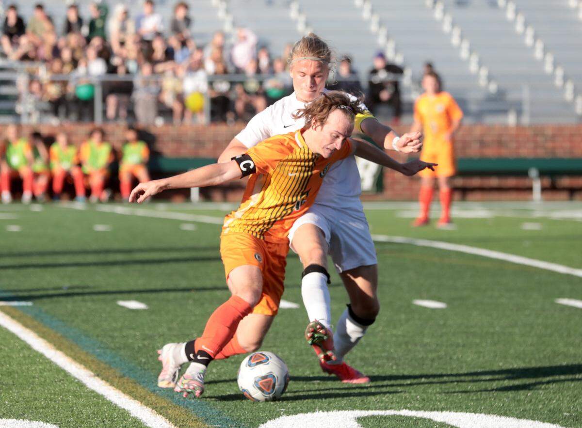 Catawba Ridge’s Dalton Bailey, left, and A.C. Flora’s Jackson Price dribble the ball Friday in Fort Mill